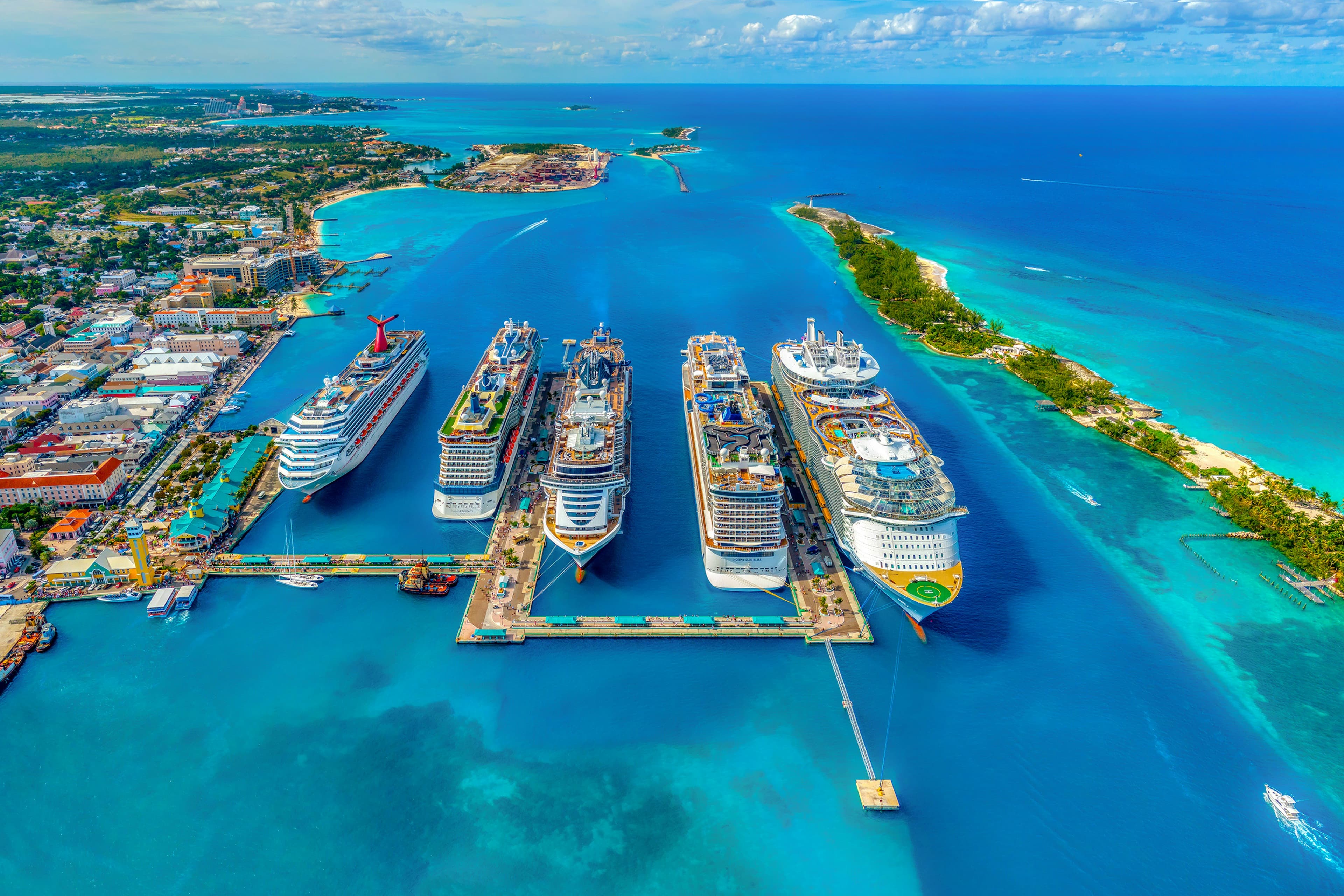 Elegant cruise ship moving through clear blue water near shore