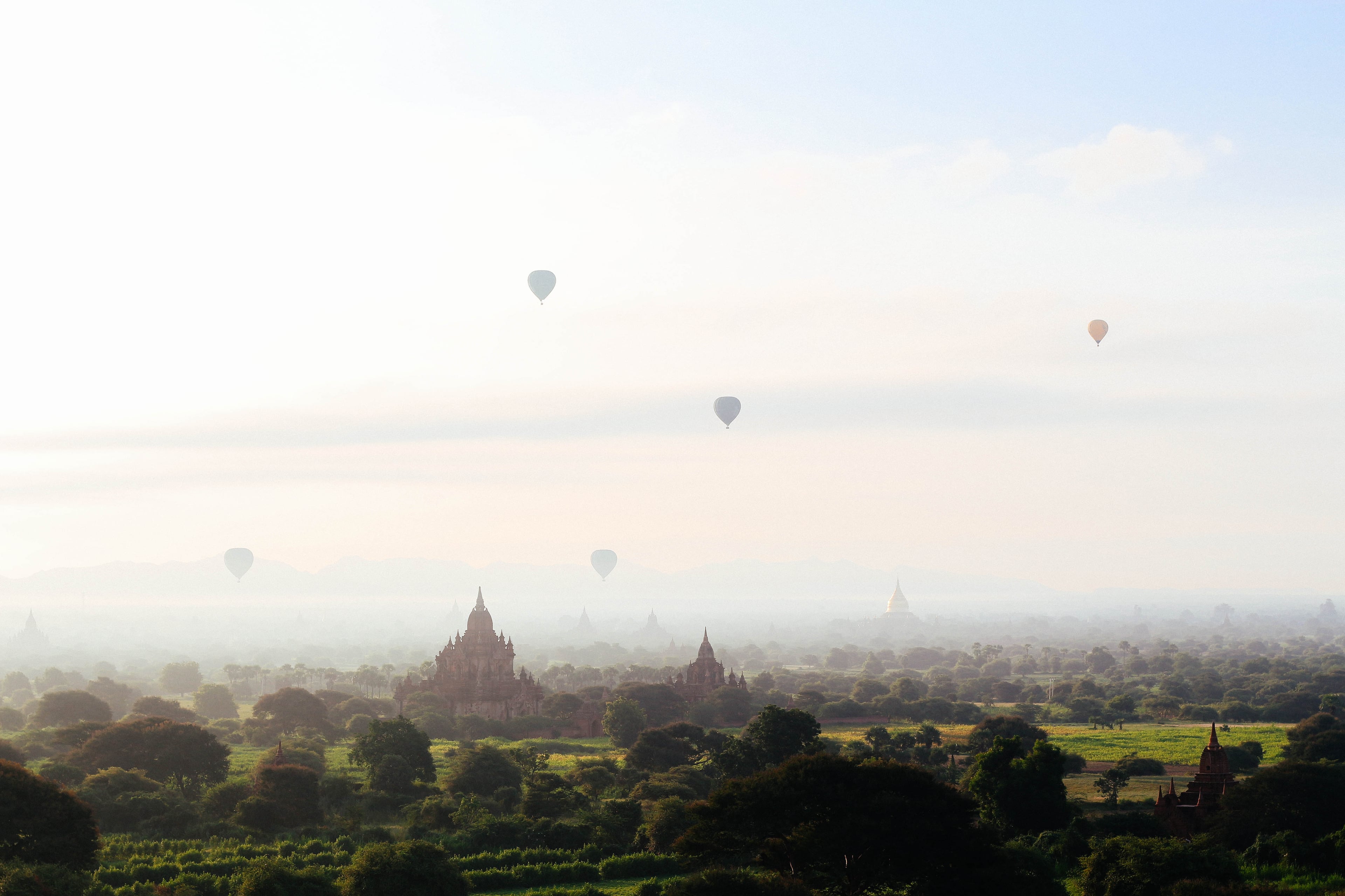 Hot air balloons rising over the temple plain of Bagan in Myanmar