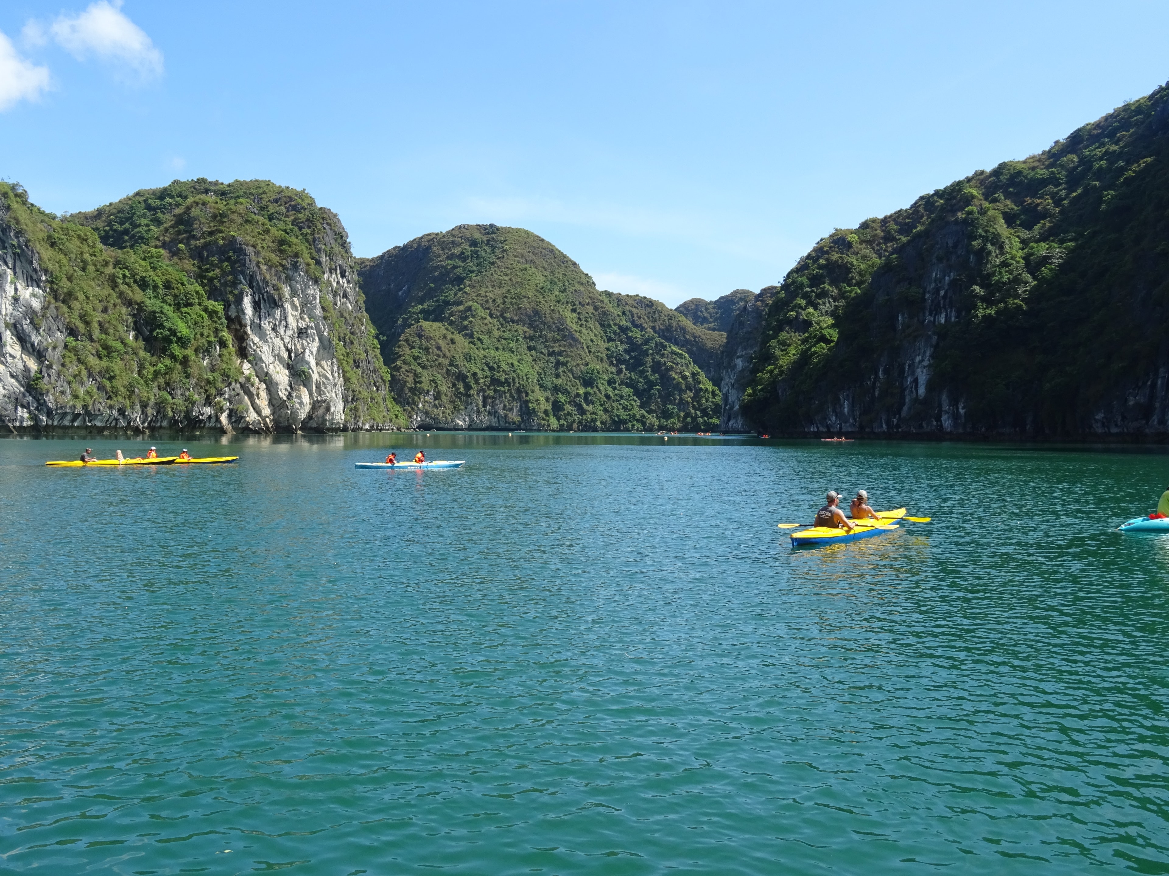 Private guests kayaking through Ha Long Bay limestone scenery