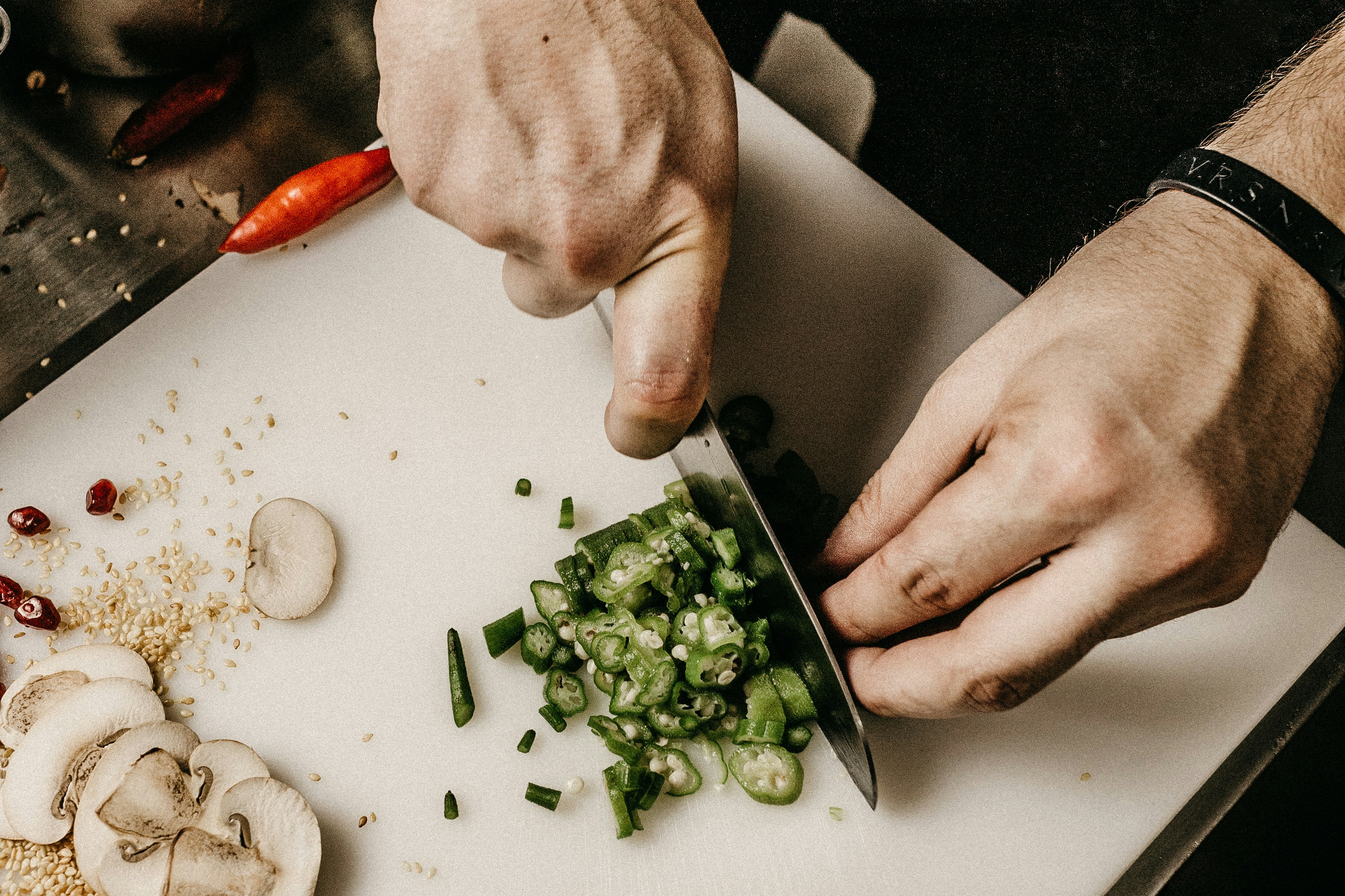 Chef plating refined dishes in a warm open kitchen